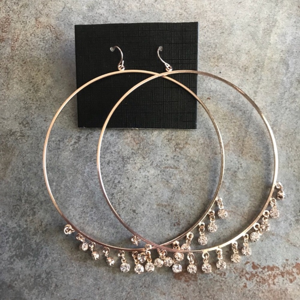 Large gold hoop earrings with dangling jewelry
